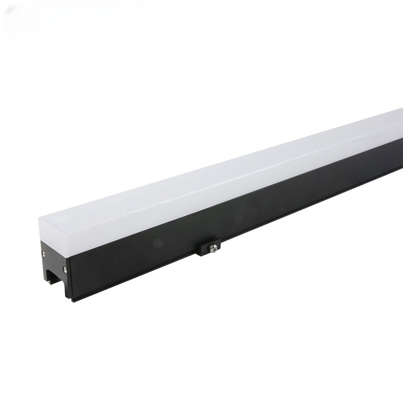 Linear LED facade lights create a vibrant glow on a commercial structure.